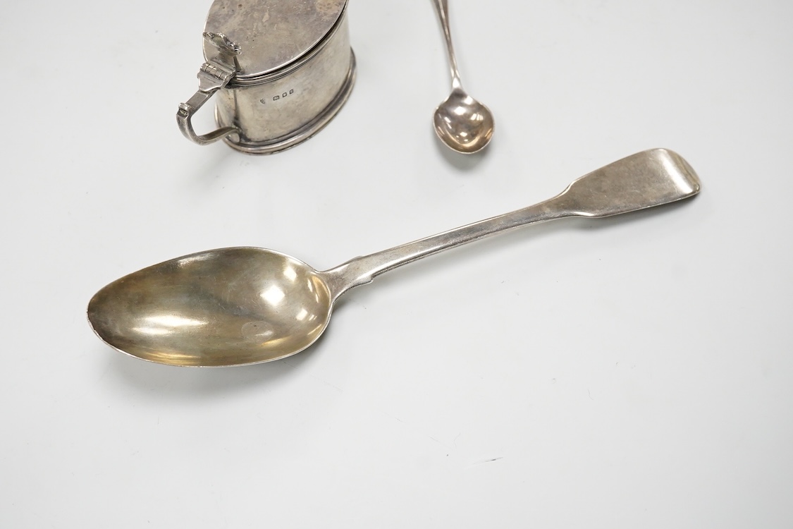 A William IV silver fiddle pattern table spoon by Richard Britton, London, 1834, together with a George V silver oval mustard pot, with blue glass liner, Edward Barnard Sons Ltd, London, 1931 and a silver coffee spoon.